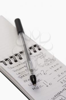 Close-up of a pen on a spiral notebook