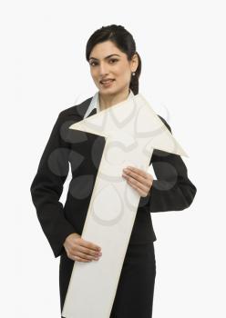 Businesswoman holding an upward arrow sign