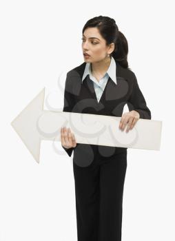 Businesswoman holding an arrow sign