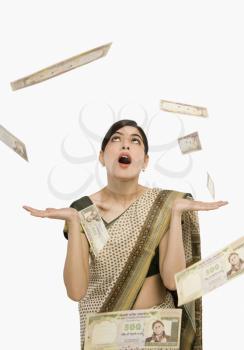 Money falling over a woman