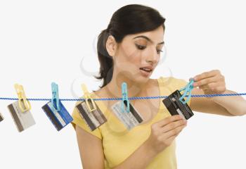 Woman hanging credit cards on a clothesline
