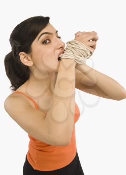 Woman's hands tied with a rope