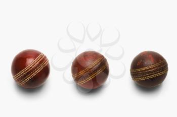 Close-up of old and new cricket balls in a row