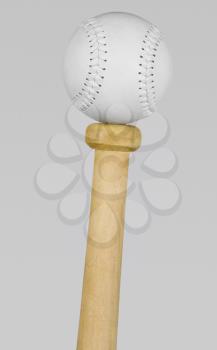 Baseball balancing on the top of a bat handle