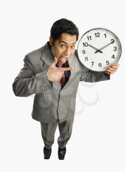 Businessman showing a clock