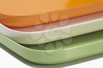Close-up of a stack of colorful trays representing Indian flag colors