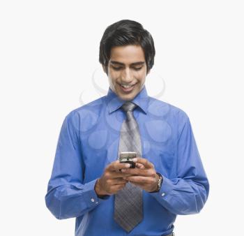 Businessman text messaging on a mobile phone