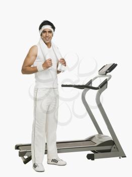 Man standing beside a treadmill