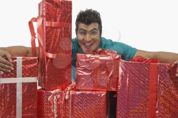 Man holding gift boxes and looking excited
