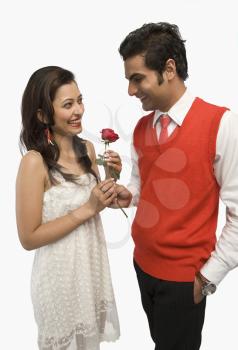 Man giving a rose to his girlfriend
