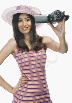 Close-up of a woman filming herself with a home video camera