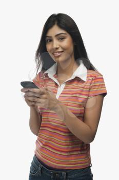 Portrait of a woman text messaging on a mobile phone