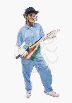 Portrait of a female cricketer holding a cricket bat