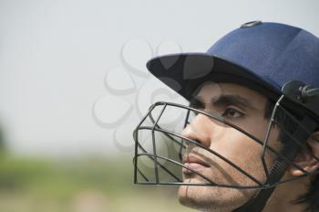 Cricket batsman wearing a helmet