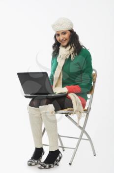 Woman using a laptop and smiling