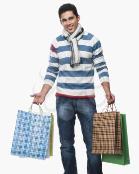 Portrait of a man carrying shopping bags