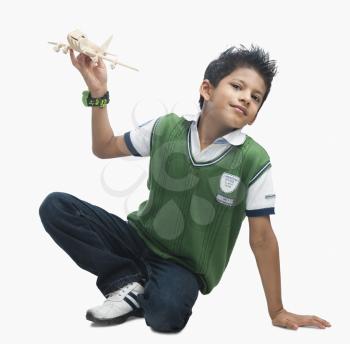 Portrait of a boy playing with a toy airplane