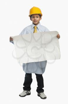 Boy dressed as an architect and showing a blueprint