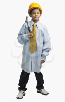 Boy dressed as an architect and holding a hammer