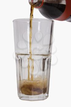 Close-up of cold drink being poured into a glass