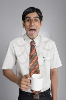 Man holding a coffee cup and shouting