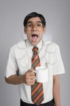 Man holding a coffee cup and shouting