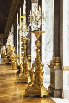 Statues with gilded lamps in a palace, Hall Of Mirrors, Chateau de Versailles, Versailles, Paris, France