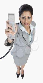 Portrait of a businesswoman holding a telephone receiver