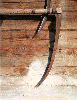 old scythes on wall