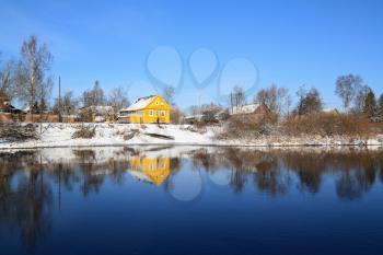 yellow house on coast river