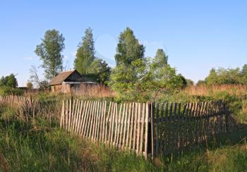 old wooden fence near farmhouse