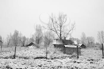 old rural house on snow field