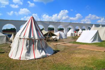 white tents near ancient wall
