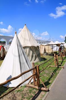 white tents near ancient wall