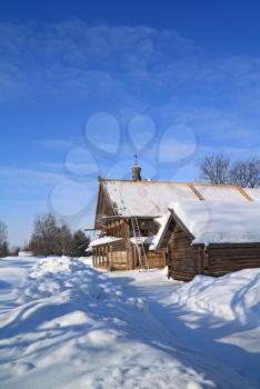 old farmhouse amongst white snow