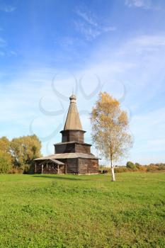 wooden chapel on green field