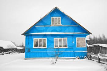 blue house amongst white snow