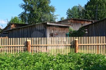 new wooden fence in rural vegetable garden