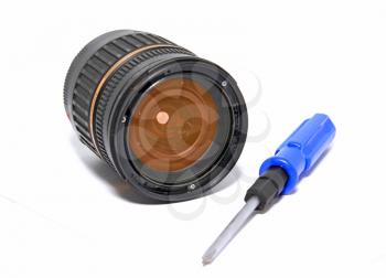 lens and screwdriver on white background