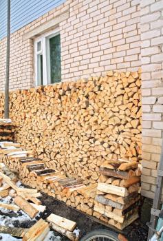 firewood near wall of the rural building