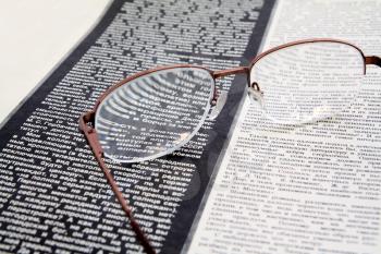 spectacles on newspaper