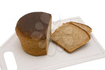 Black bread on a chopping board, on a white background.                   