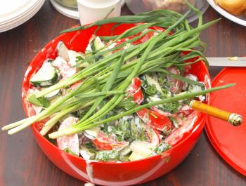 Salad with green onions on a table.                   
