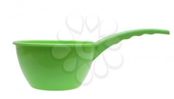 Green plastic ladle on a white background.                   