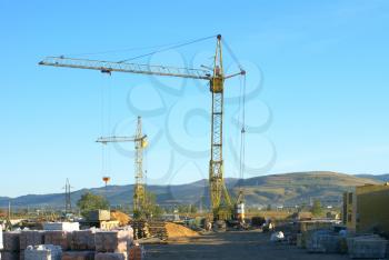 Building site with tower cranes against the sky.                 