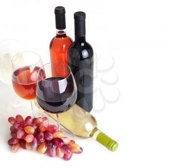 wineglass, bottles of wine and grapes