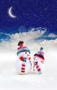 two snowman in snow