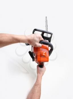 man hands holding a chainsaw