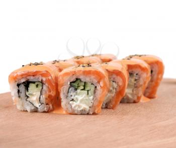 Sushi rolls with mayonnaise, cucumber, salmon, seaweed on white