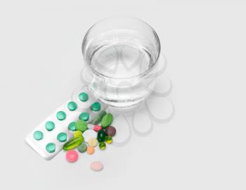 glass of water and vitamins, pills and tablets